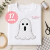 Ghost applique machine embroidery design on a white sweatshirt for Halloween