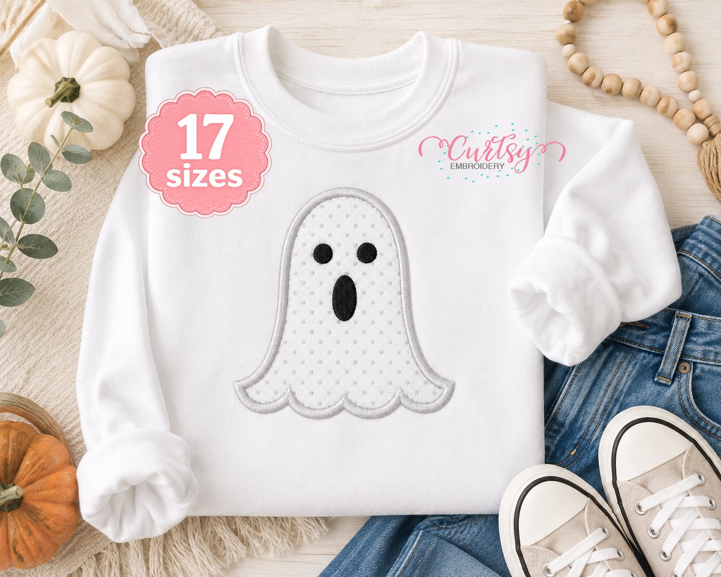 Ghost applique machine embroidery design on a white sweatshirt for Halloween