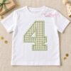 AI-assisted mockup of number 4 gingham applique on a white child’s shirt with a wrapped gift and birthday decorations.