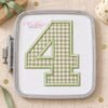 AI-assisted mockup of sage gingham number 4 applique on white fabric in a gray plastic machine embroidery hoop.