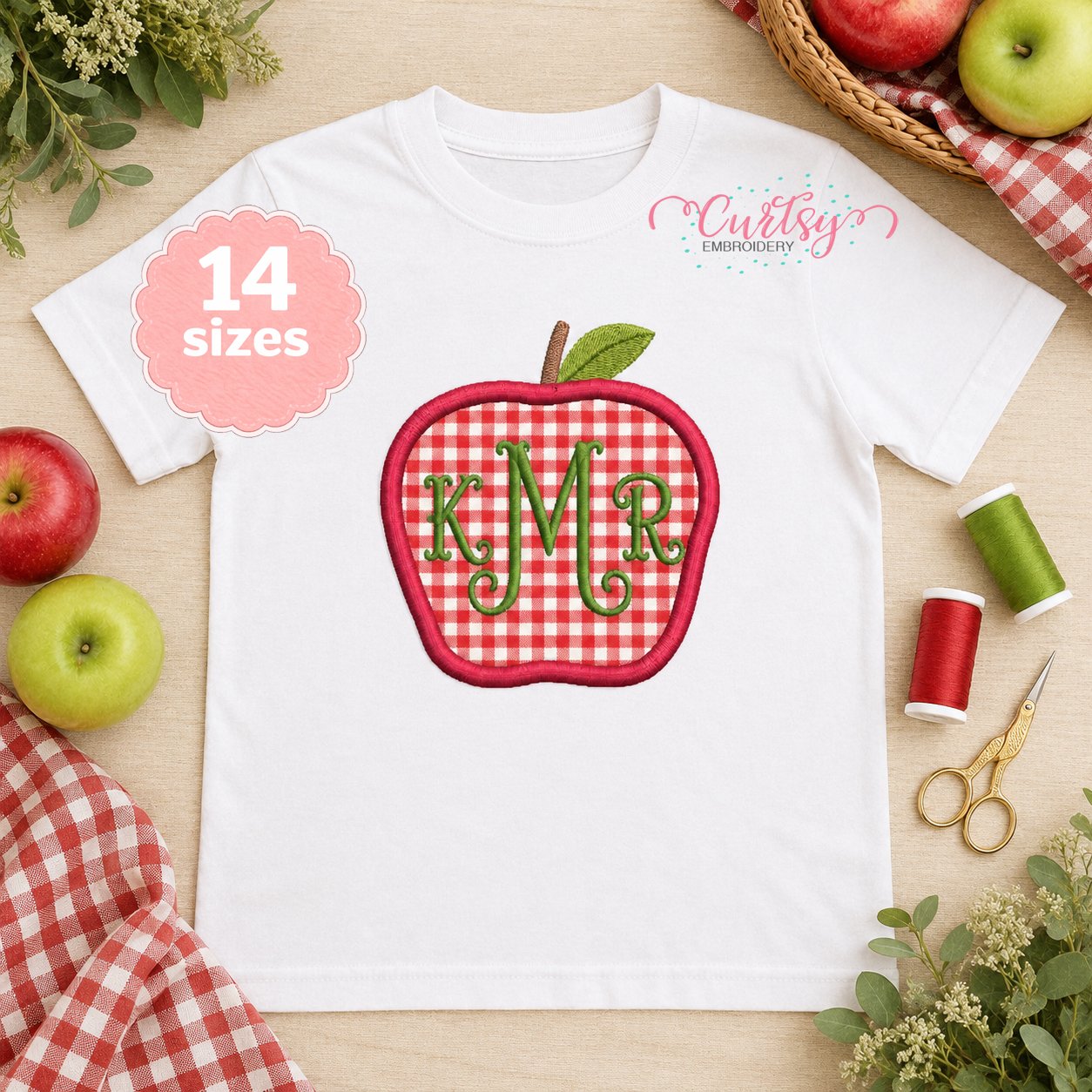 Red gingham apple applique personalized with a green three-letter monogram on an open white shirt