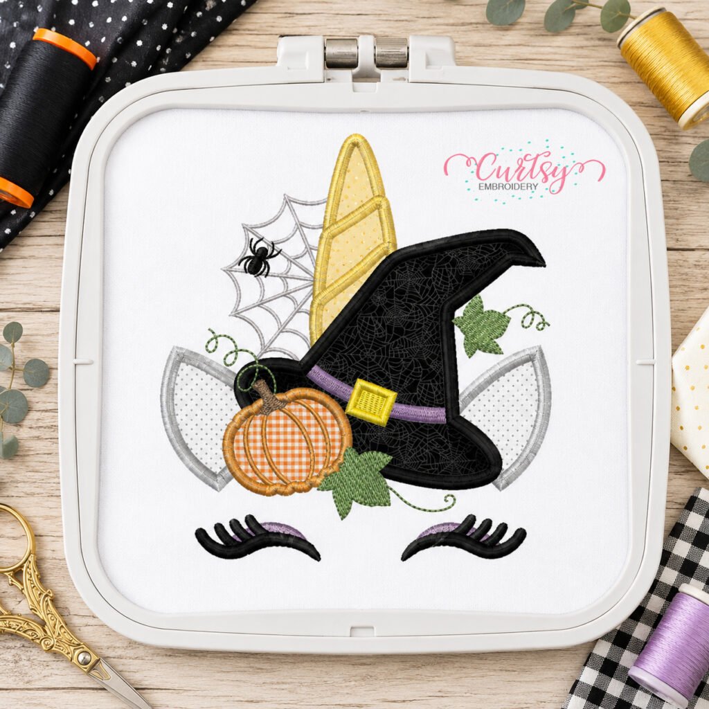 Halloween unicorn applique design stitched in a plastic machine embroidery hoop