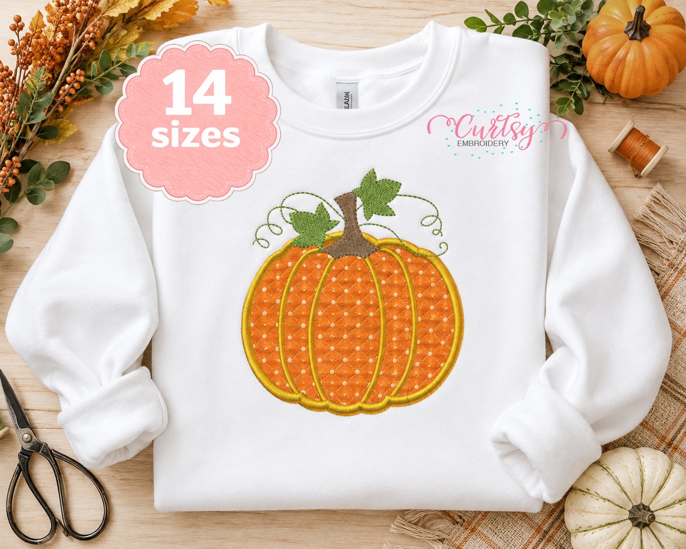 Pumpkin applique machine embroidery design on a white sweatshirt