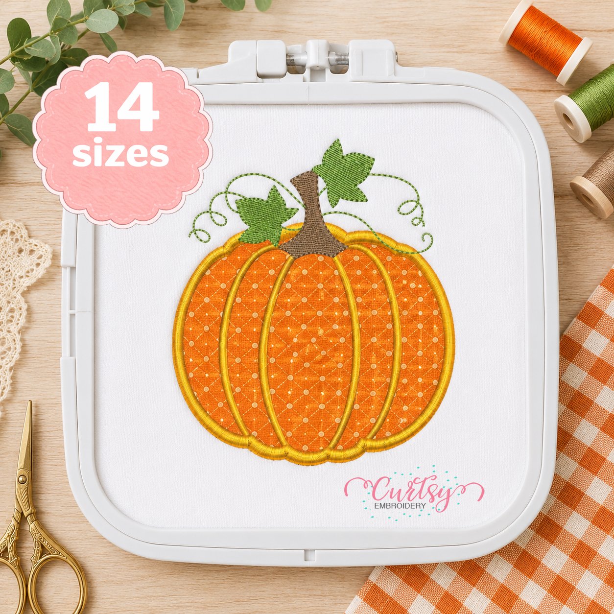 Pumpkin applique design stitched in a plastic machine embroidery hoop