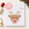 Boy reindeer quick stitch embroidery design with cream antlers and a red nose stitched on a folded white shirt.