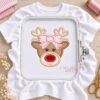 Girl reindeer face appliqué stitched on a shirt held in a plastic embroidery machine hoop