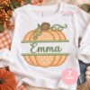 Split pumpkin applique embroidery design personalized with embroidered name on white shirt