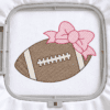 Football with bow embroidery design shown in a plastic machine embroidery hoop