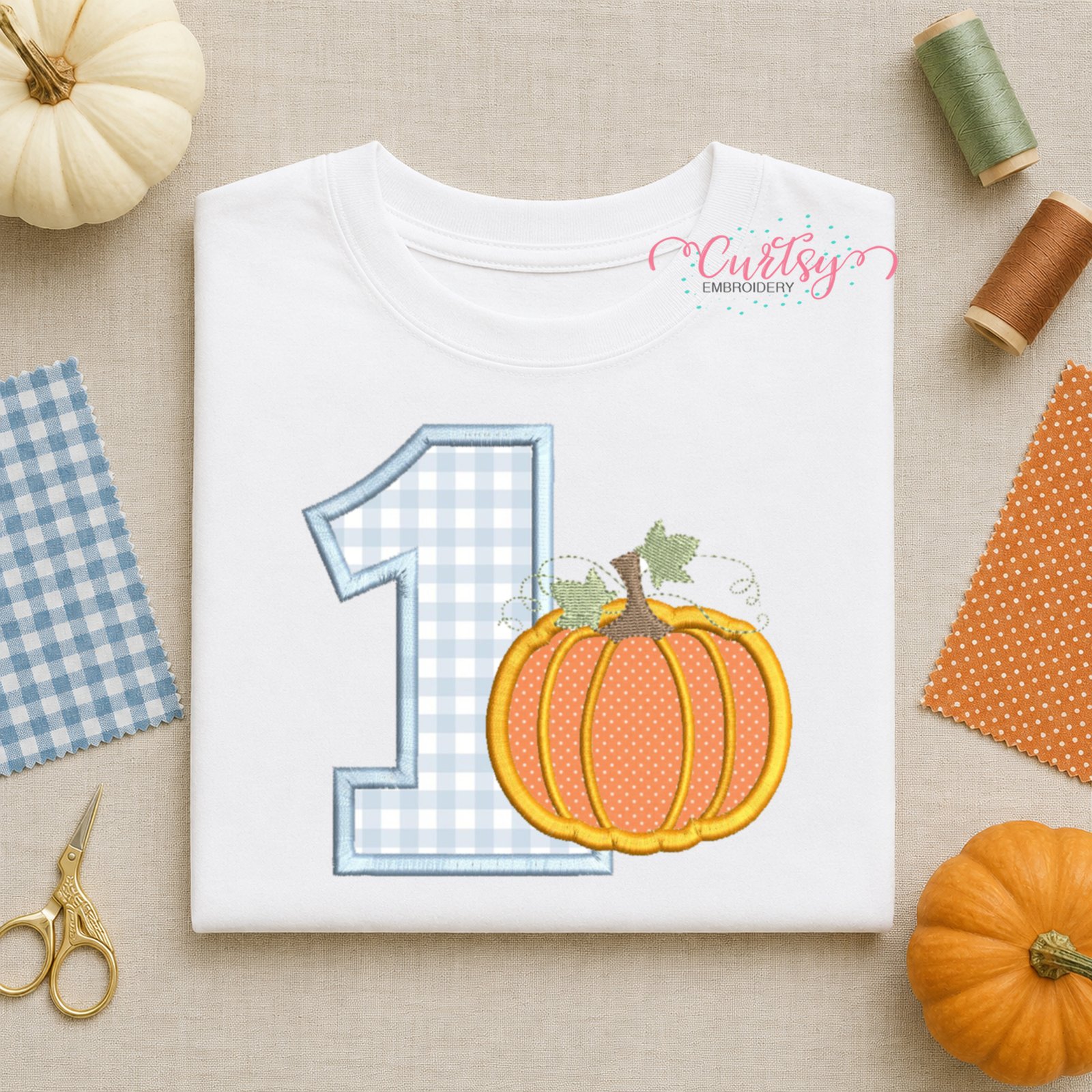 Personalized first birthday bodysuit featuring a pumpkin applique embroidery design