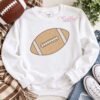 Football sketch fill machine embroidery design on a white sweatshirt