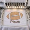 Football sketch fill embroidery design personalized with the name Mason in an embroidery machine