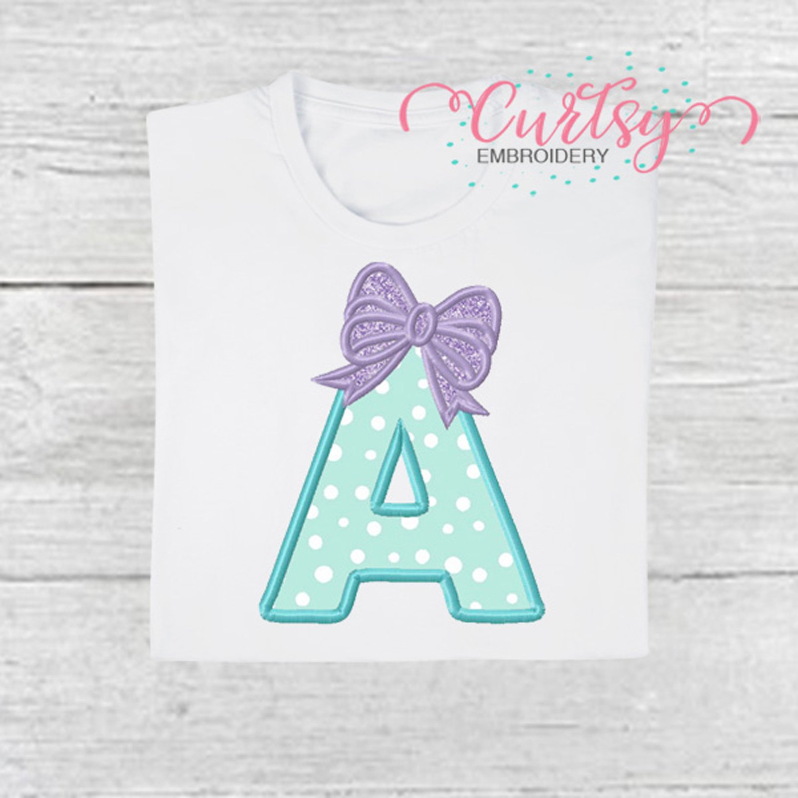 A Bow Monogram Applique by Curtsy Embroidery A Bow Monogram Applique by Curtsy Embroidery