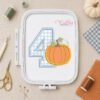 4th Birthday Pumpkin Applique Embroidery Design stitched in a plastic machine embroidery hoop.