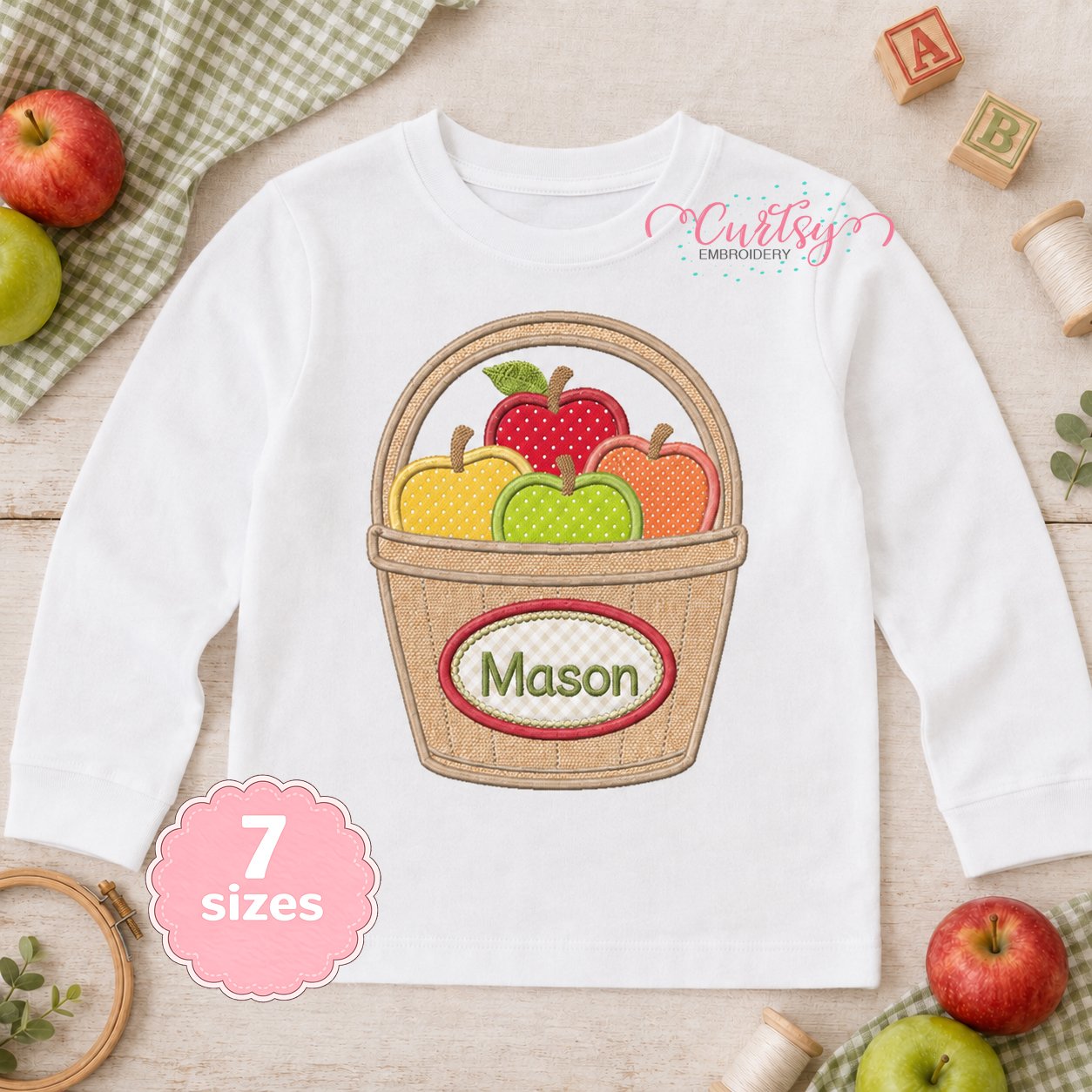 Apple Basket Applique Design _ Logo 1 Apple Basket Monogram Applique embroidered on an open white shirt with the name Mason
