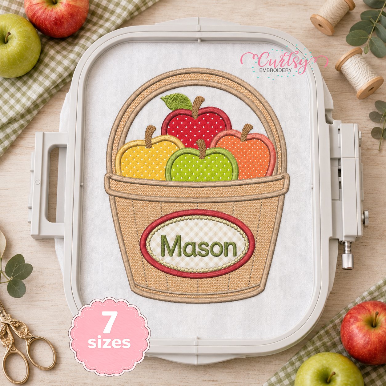 Apple Basket Applique Design _ Logo 2 Apple Basket Monogram Applique with Mason stitched on white fabric in a plastic embroidery machine hoop
