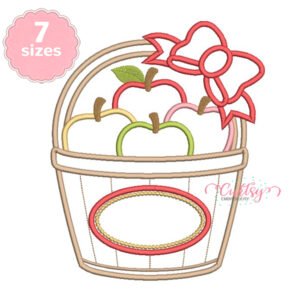 Apple basket with bow applique embroidery design stitched on a folded white shirt