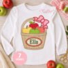 Apple basket with bow embroidery design personalized with a girl’s name inside the oval
