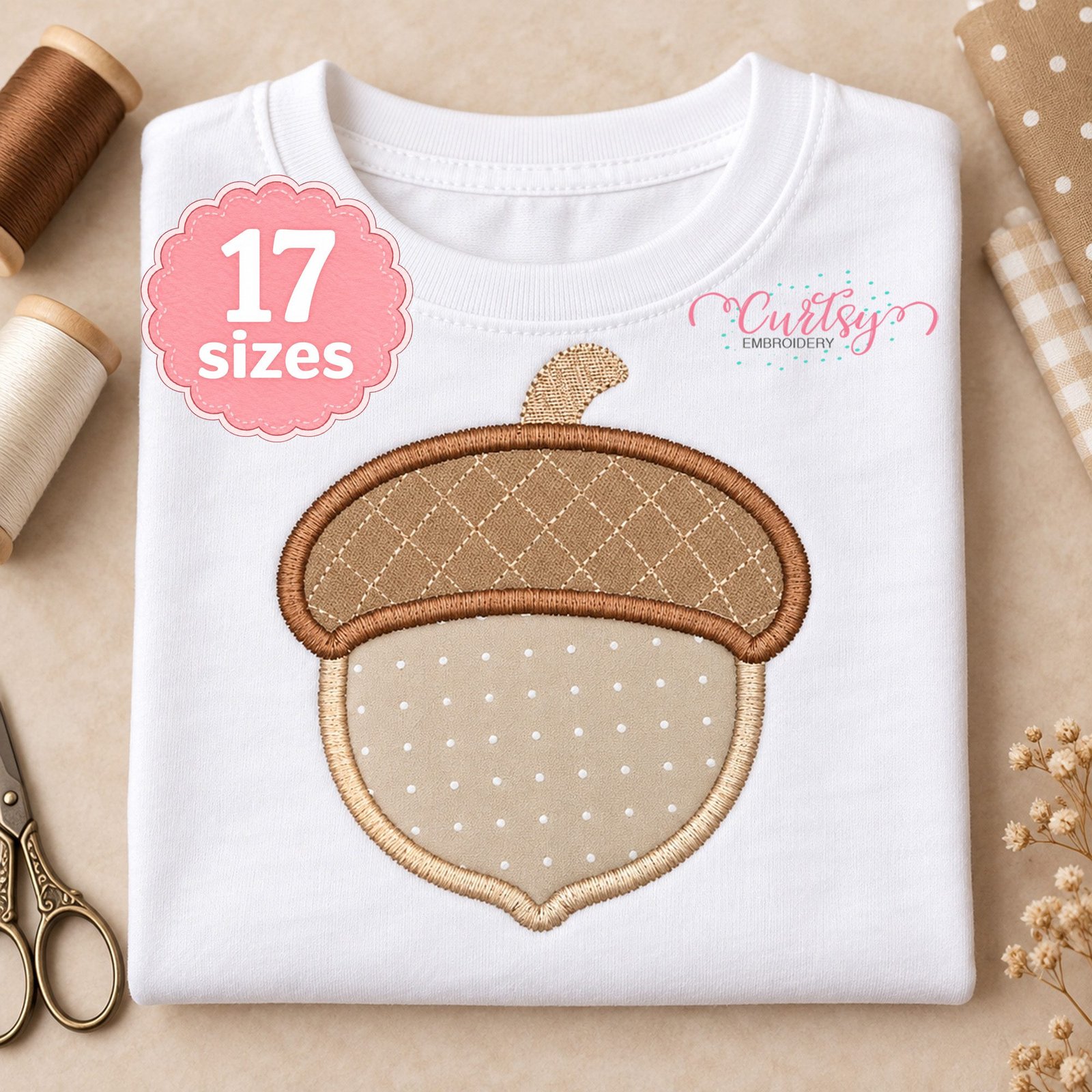 Acorn applique embroidery design stitched on a folded white shirt