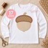 Acorn applique embroidery design displayed on an open white long-sleeve shirt