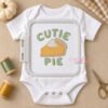 Cutie Pie design stitched on a baby bodysuit inside a plastic embroidery hoop