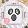 Ghost Face applique design stitched on white fabric in a rectangular embroidery machine hoop