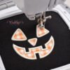 ack O Lantern applique actively stitching on black fabric with cream satin thread