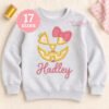Girl jack o lantern applique embroidered on an open gray sweatshirt with the name Hadley below