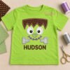 Monster Face Applique Design embroidered on a lime-green shirt with a personalized name underneath.