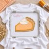 Pumpkin pie applique stitched on a white shirt in a plastic embroidery machine hoop
