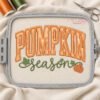 Pumpkin Season applique design stitched on fabric inside a plastic embroidery machine hoop