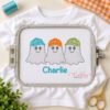 Boy Ghosts with Baseball Hats Quick Stitch Embroidery Design _ Logo 1 White shirt in a rectangular plastic embroidery machine hoop with the boy ghost trio and the name Charlie stitched below.