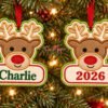 Boy Reindeer Christmas Applique Design _ Logo 1 Two reindeer applique ornaments hanging on a Christmas tree, one personalized with Charlie and the other embroidered with 2026.