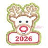 Boy Reindeer Christmas Applique Design _ Website 2 Boy reindeer ornament applique embroidery design with antlers, a red nose, stitched hanging eyelet, and red 2026 lettering on a panel framed by red dots and a green border.