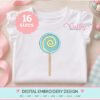 Lollipop Applique Design 600 Lollipop applique machine embroidery design on a folded white children's top, featuring a teal polka-dot fabric center, yellow embroidered swirl, aqua satin border, and tan stick. Includes 16 sizes.
